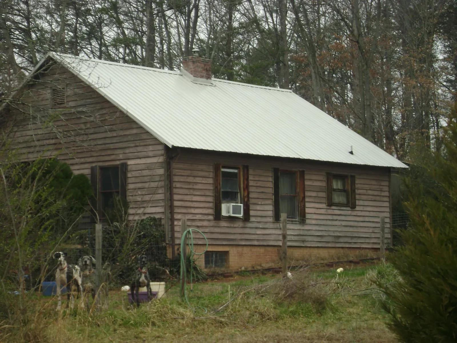 White metal roof on an old wood sided farmhouse, from a Metal Roof Installation job in Berea
